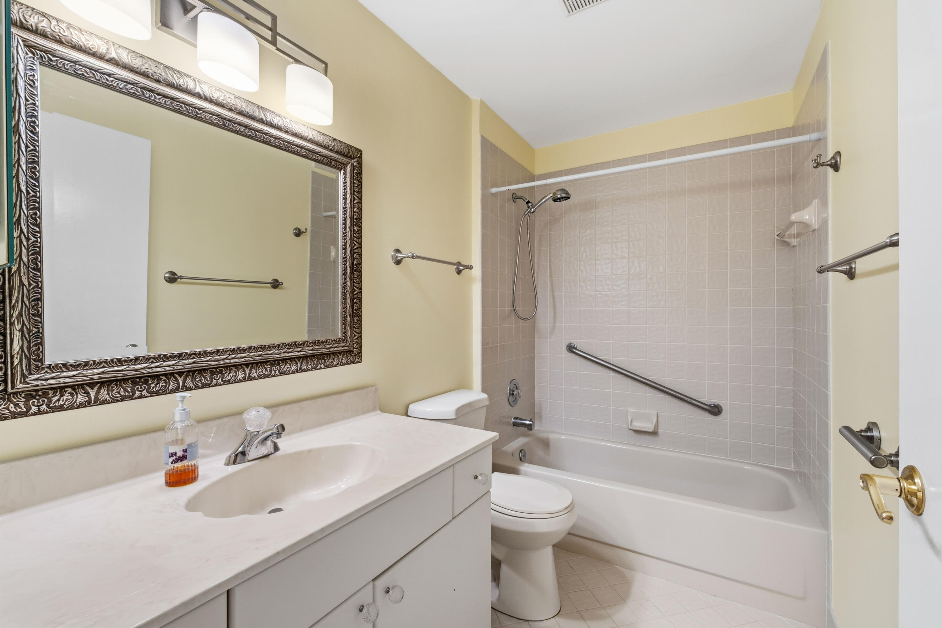 3233 Perimeter Drive, Unit 2511 Greenacres, FL 33467 - Photo 17 of 39 a bathroom with a sink mirror toilet and bathtub