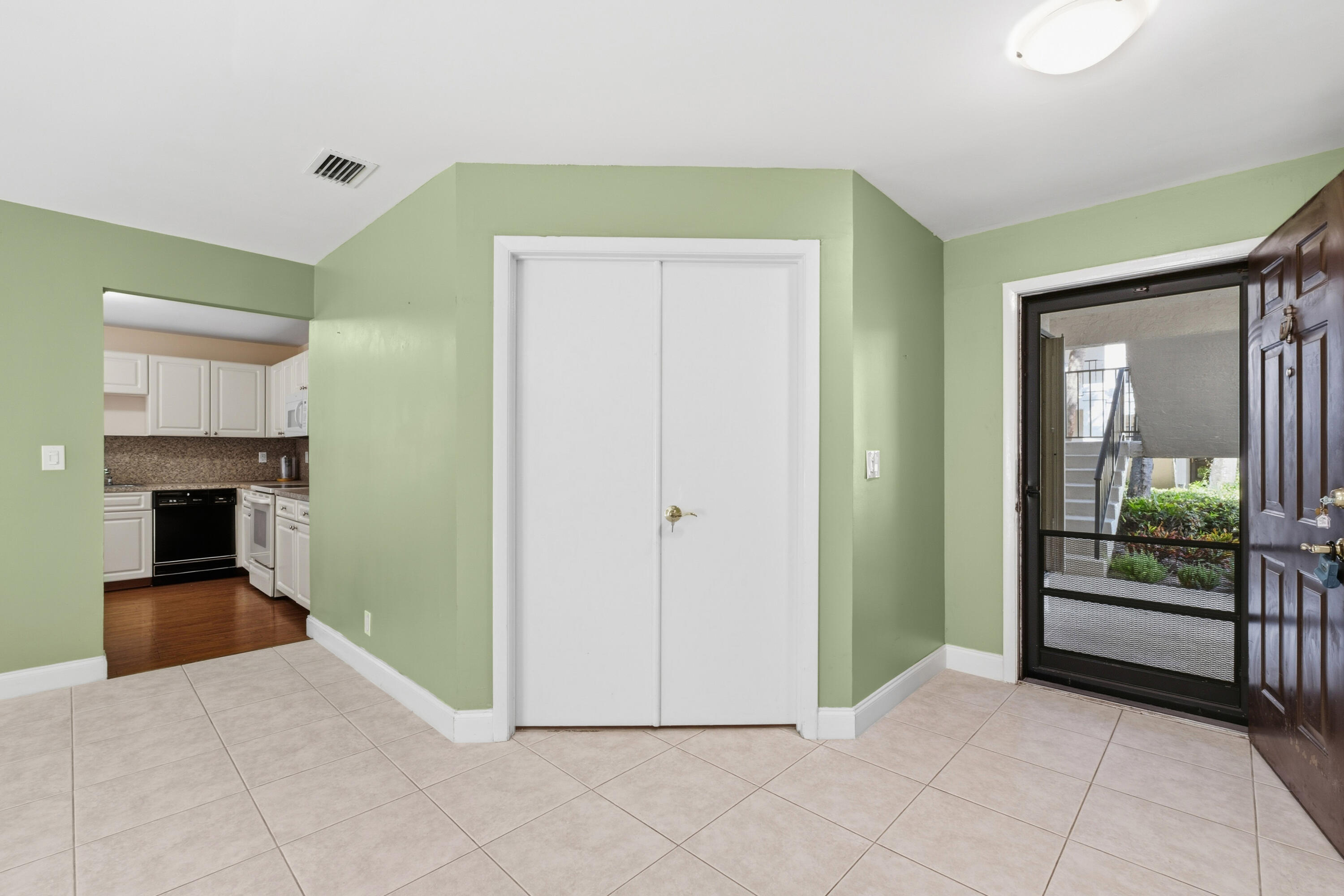 3233 Perimeter Drive, Unit 2511 Greenacres, FL 33467 - Photo 18 of 39 a view of a hallway to rooms and stairs