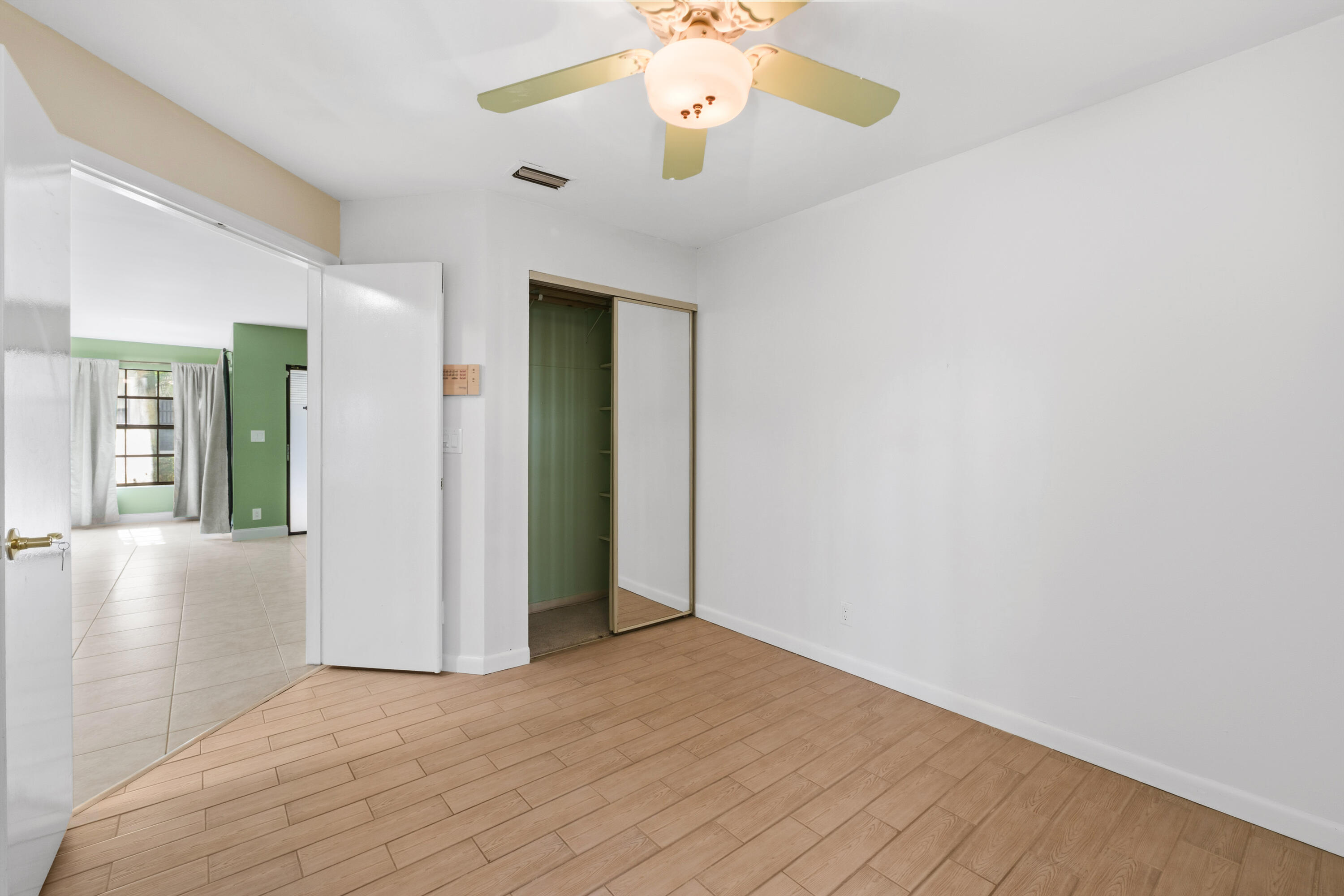 3233 Perimeter Drive, Unit 2511 Greenacres, FL 33467 - Photo 20 of 39 a view of an empty room with a chandelier fan