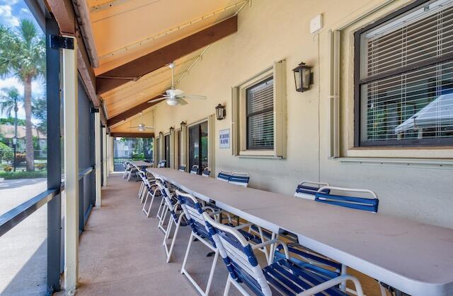 3233 Perimeter Drive, Unit 2511 Greenacres, FL 33467 - Photo 30 of 39 a view of a patio with table and chairs