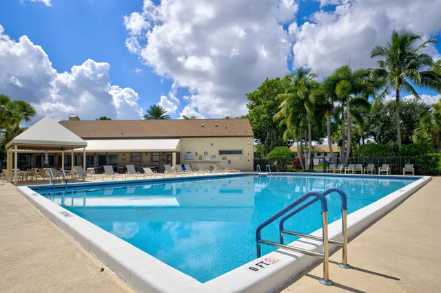 a view of swimming pool with outdoor seating and plants