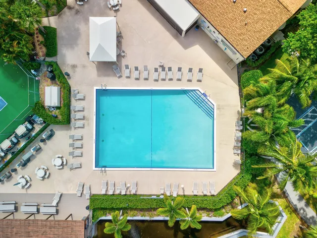 an aerial view of a house with a yard and outdoor seating