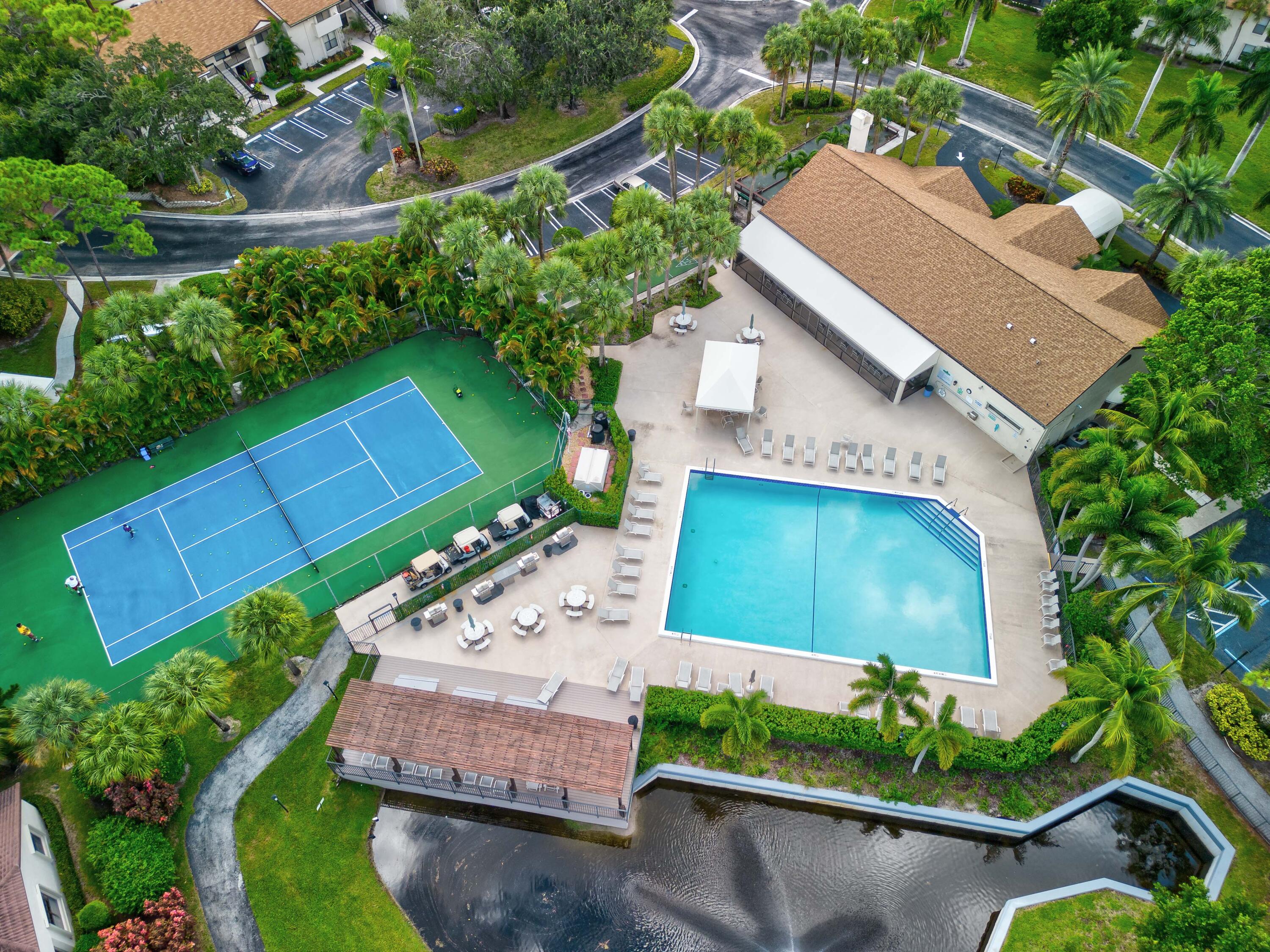 3233 Perimeter Drive, Unit 2511 Greenacres, FL 33467 - Photo 35 of 39 an aerial view of a house with a yard and outdoor seating