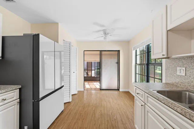 a kitchen with a refrigerator and a sink