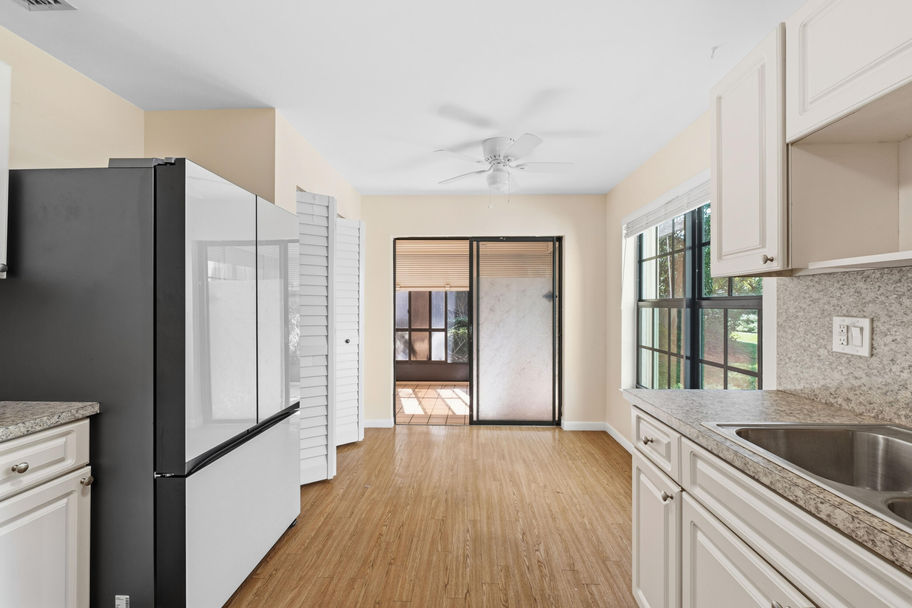 3233 Perimeter Drive, Unit 2511 Greenacres, FL 33467 - Photo 7 of 39 a kitchen with a refrigerator and a sink