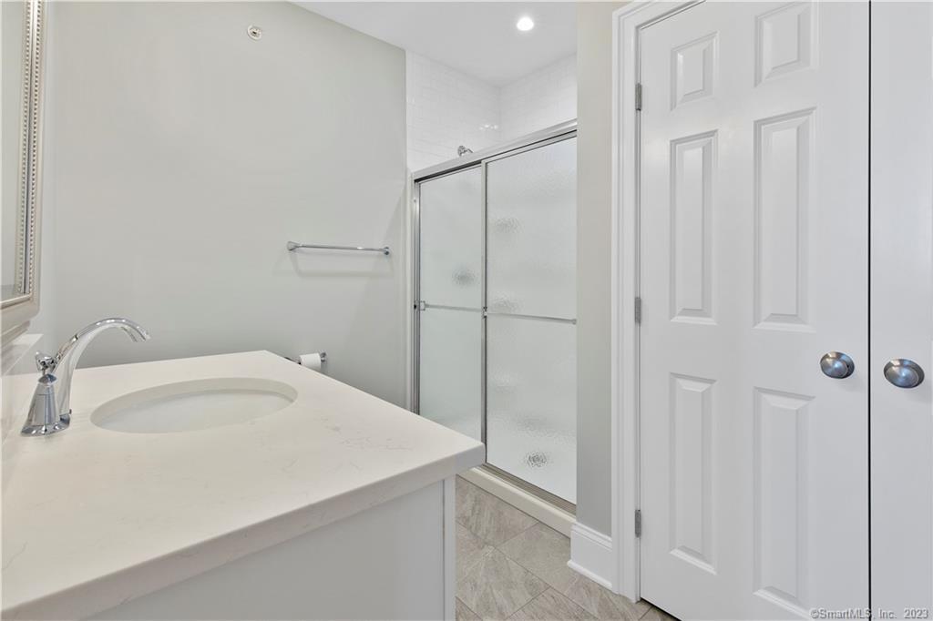 73 West Main Street, Unit 5 Clinton, CT 06413 - Photo 14 of 23 a bathroom with a sink and shower