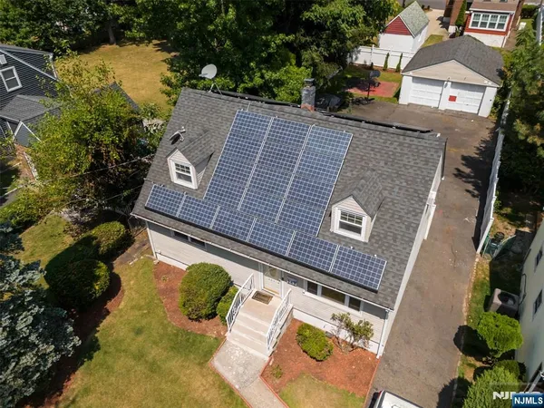 an aerial view of a house with yard swimming pool and outdoor seating