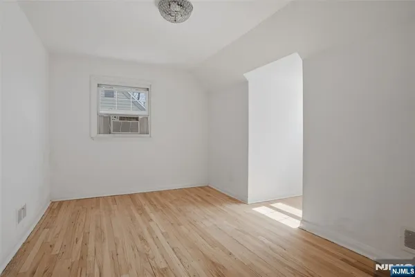a view of a room with wooden floor