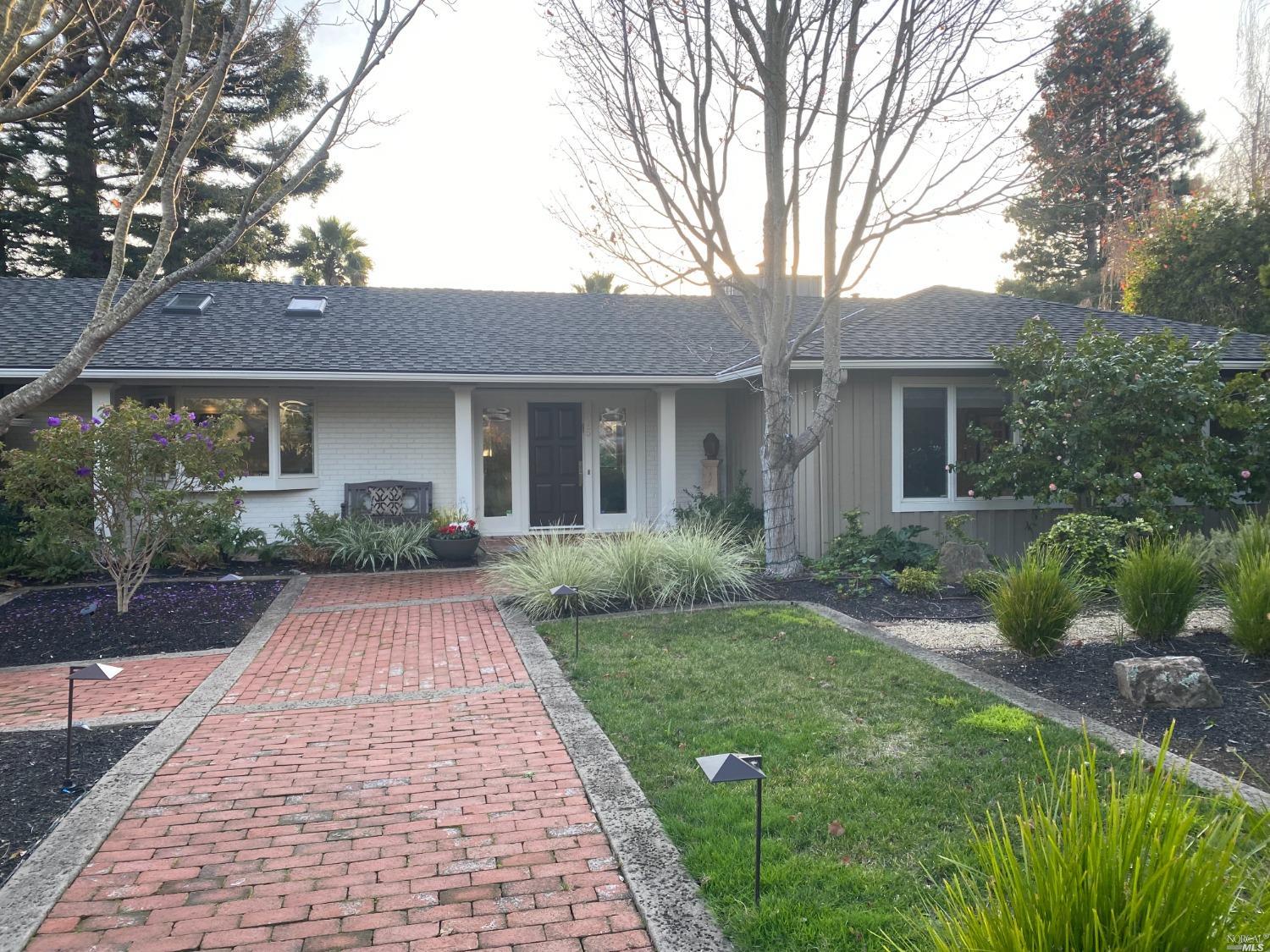 a front view of house with yard and green space