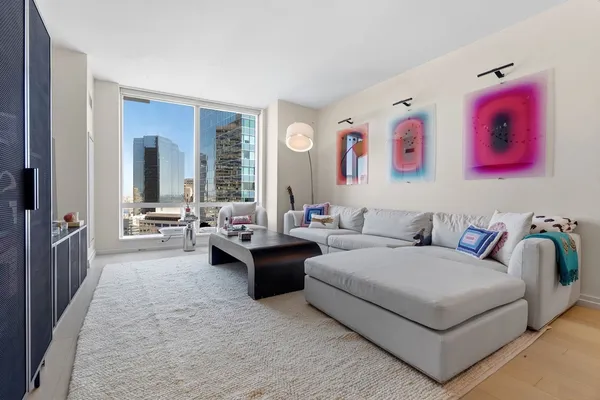 a living room with furniture and a large window
