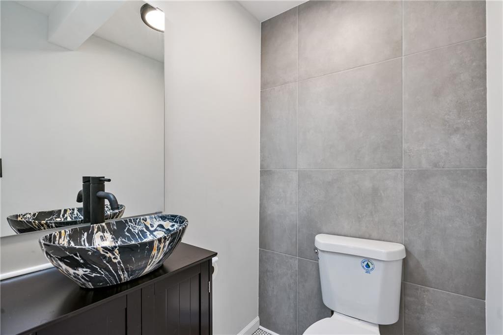 1017 McCoy Road McKees Rocks, PA 15136 - Photo 13 of 30 a bathroom with a toilet a sink and a mirror