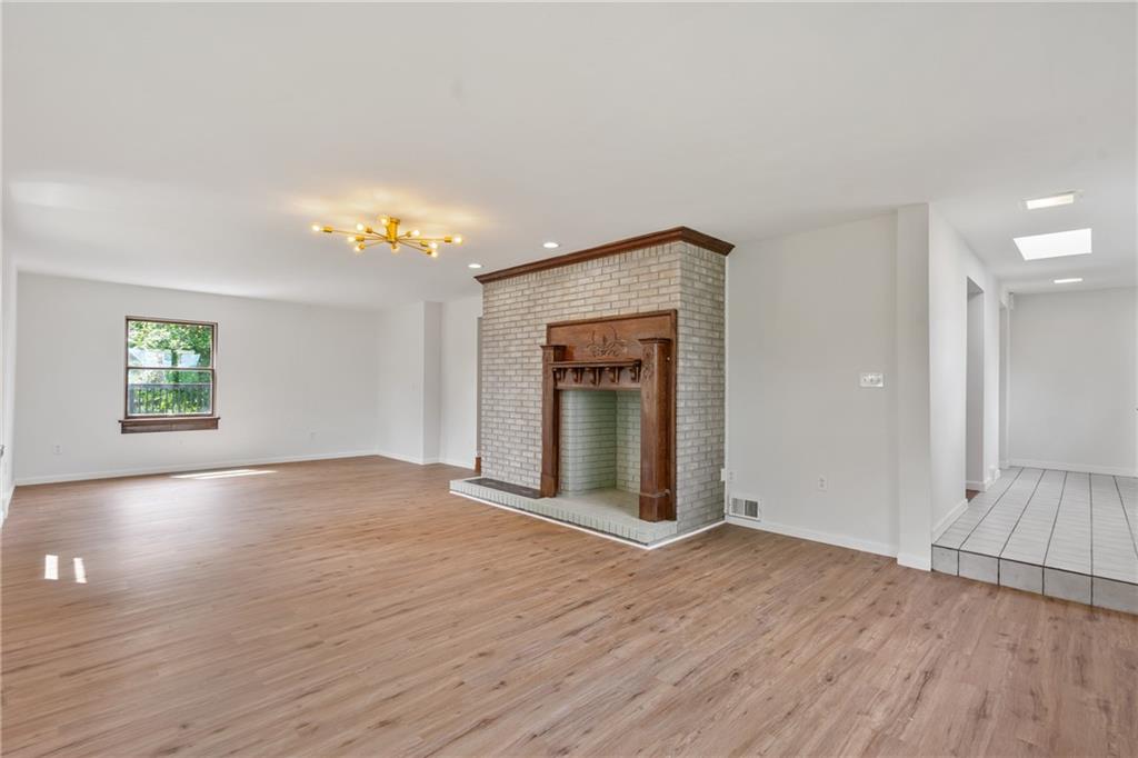 1017 McCoy Road McKees Rocks, PA 15136 - Photo 10 of 30 an empty room with wooden floor fireplace and windows