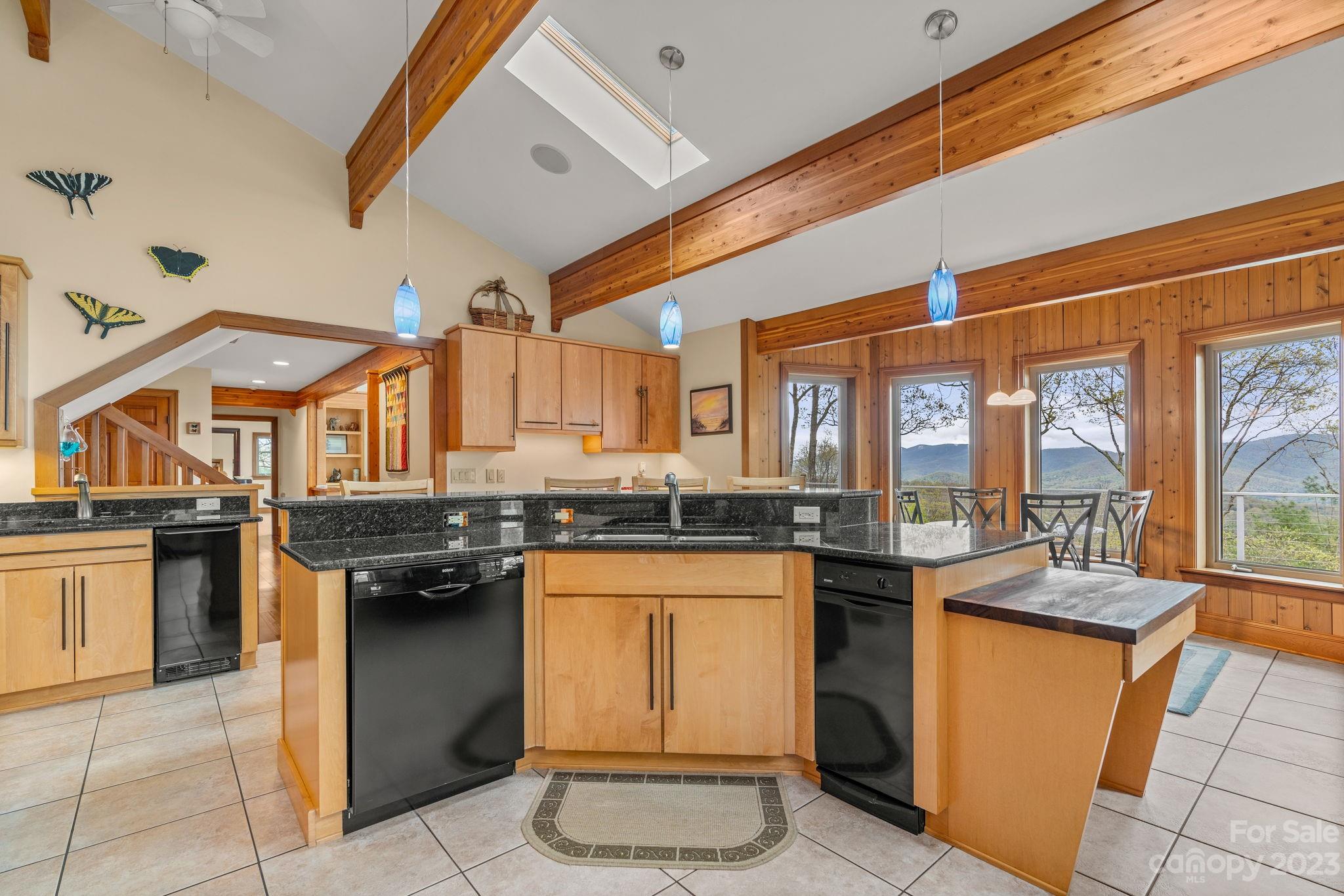 202 Mt Olive Drive Asheville, NC 28804 - Photo 18 of 48 a kitchen with stainless steel appliances granite countertop a stove a sink dishwasher and a microwave oven with cabinets