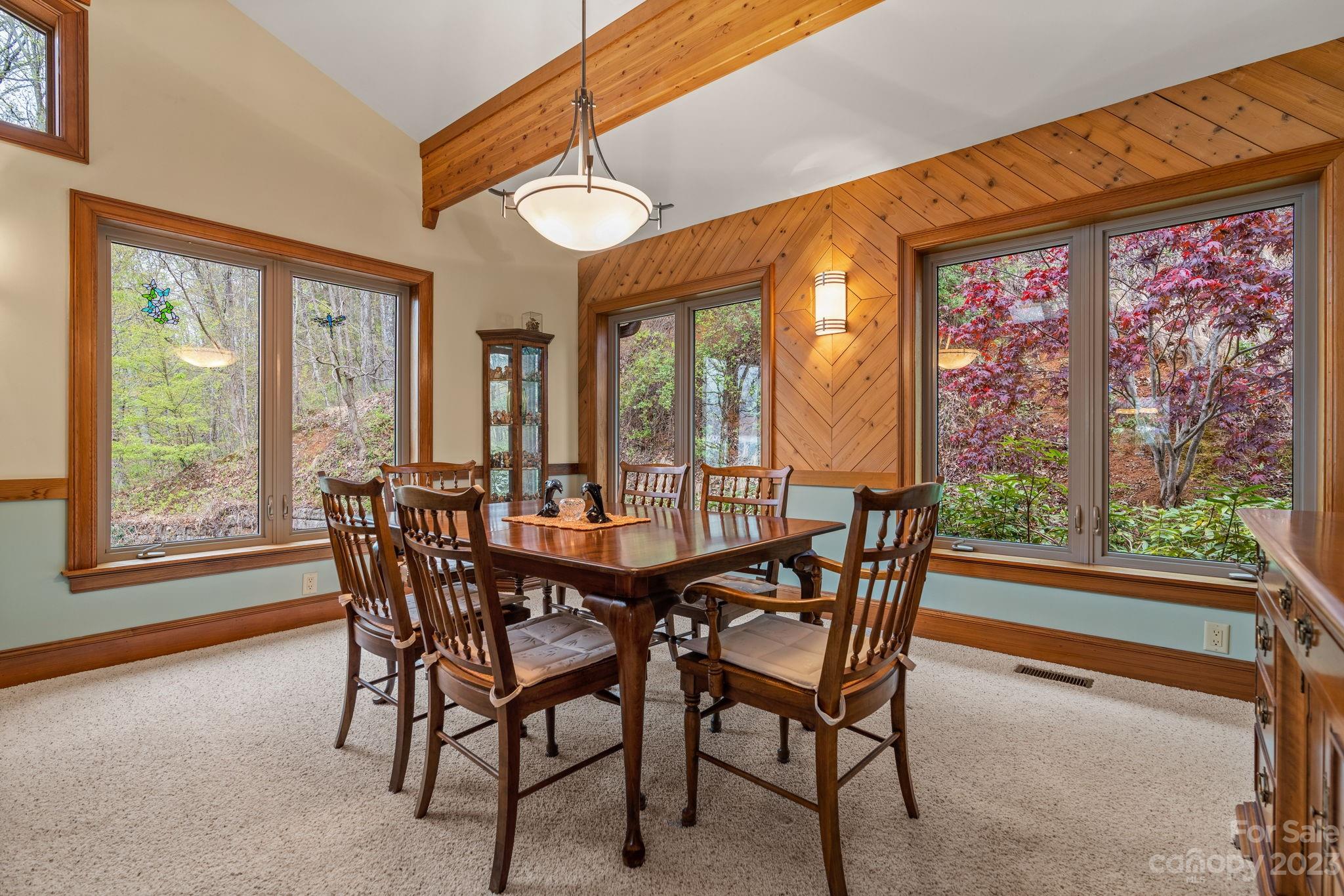 202 Mt Olive Drive Asheville, NC 28804 - Photo 25 of 48 a view of a dining room with furniture large windows and wooden floor