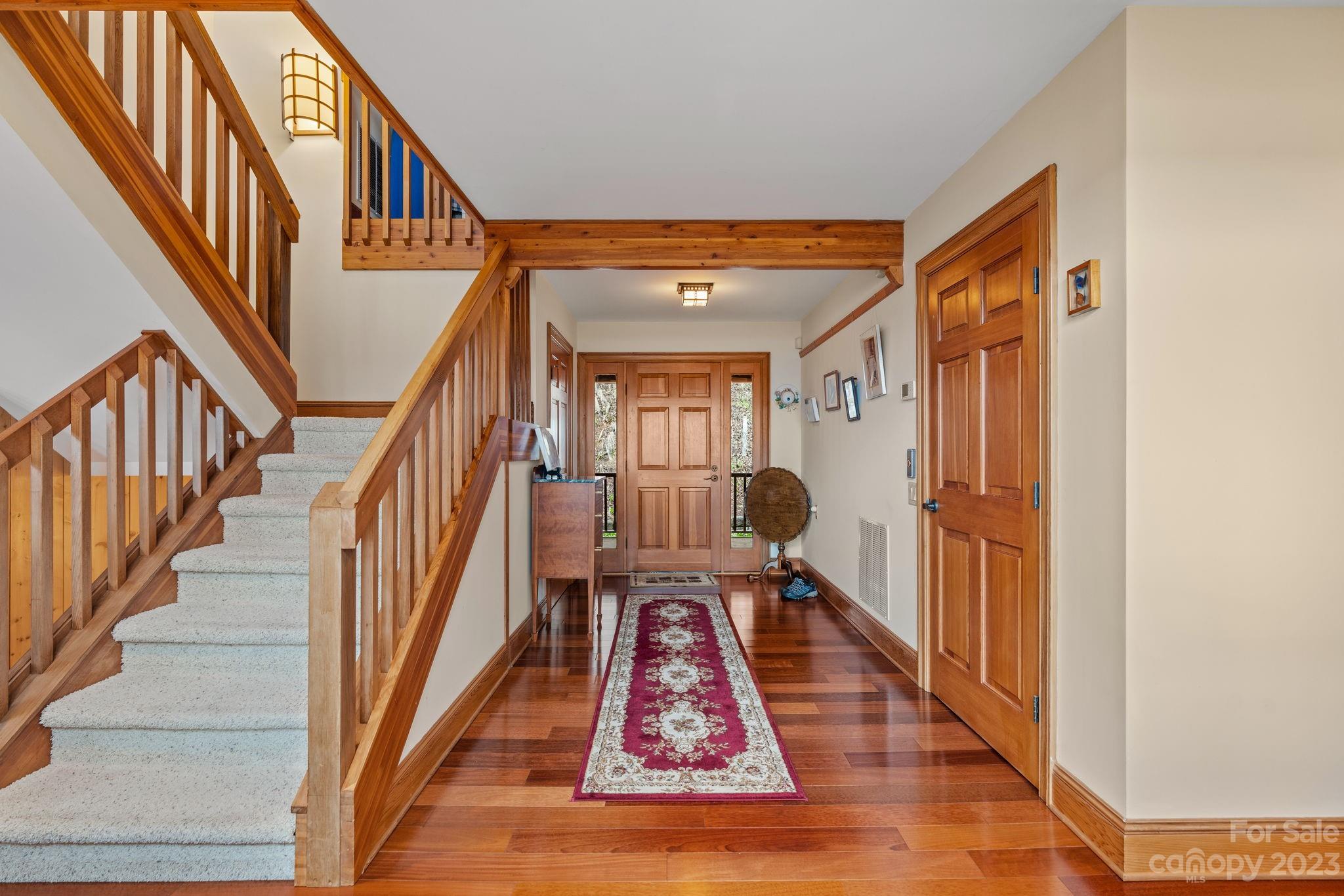 202 Mt Olive Drive Asheville, NC 28804 - Photo 8 of 48 a view of staircase with wooden floor and a rug