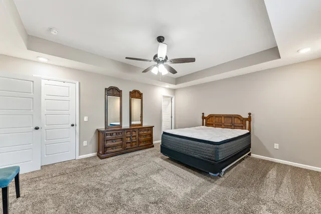 a bathroom with a double vanity sink toilet mirror and shower
