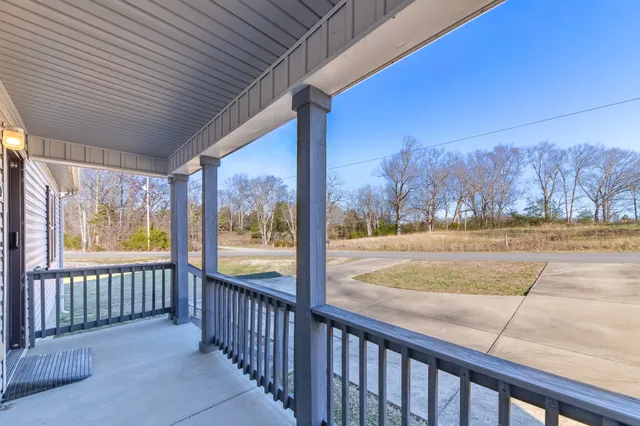 a view of a swimming pool with lounge chairs in patio