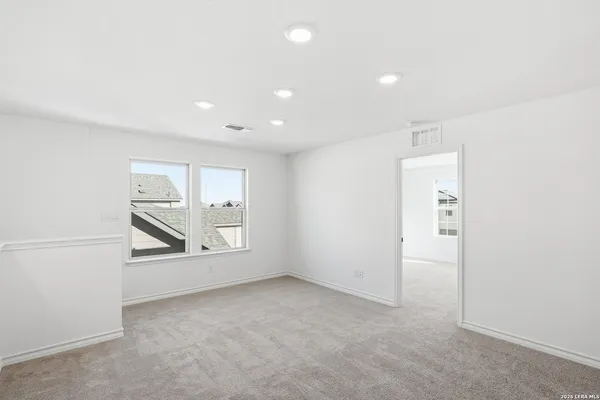 an empty room with windows and closet