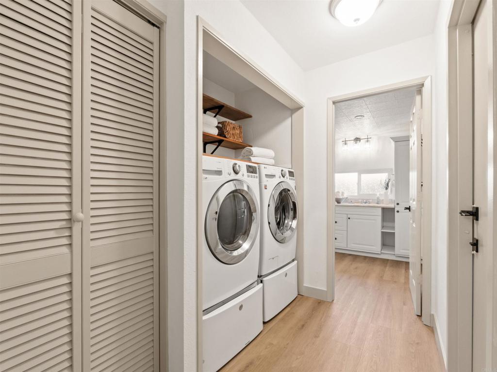 13737 Temple Street Poway, CA 92064 - Photo 30 of 38 a view of a hallway with washer and dryer