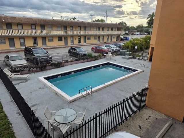 a view of a swimming pool and lounge chair