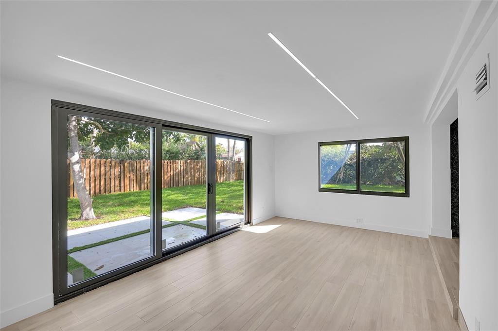 1257 Northwest 4th Street Boca Raton, FL 33486 - Photo 12 of 23 a view of an empty room with wooden floor and a window