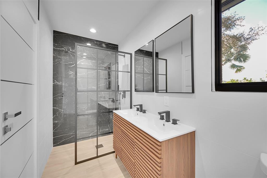 1257 Northwest 4th Street Boca Raton, FL 33486 - Photo 16 of 23 a bathroom with a sink and a mirror