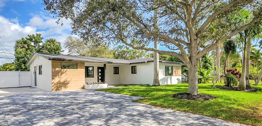 1257 Northwest 4th Street Boca Raton, FL 33486 - Photo 2 of 23 a view of a house with yard and tree s