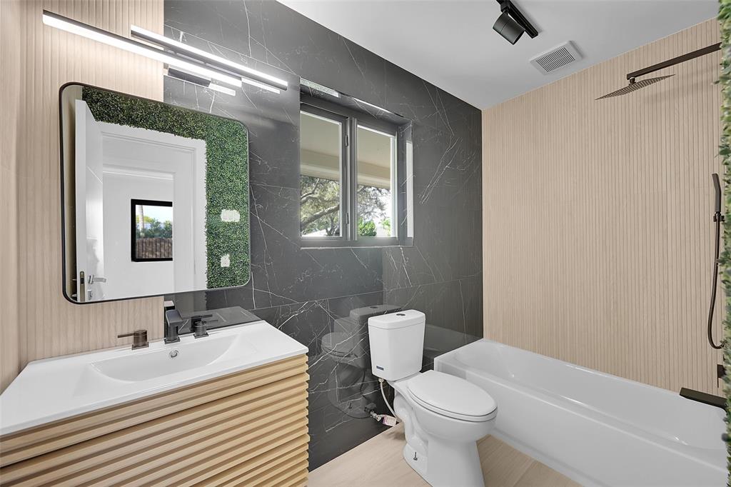 1257 Northwest 4th Street Boca Raton, FL 33486 - Photo 21 of 23 a bathroom with a sink toilet and mirror