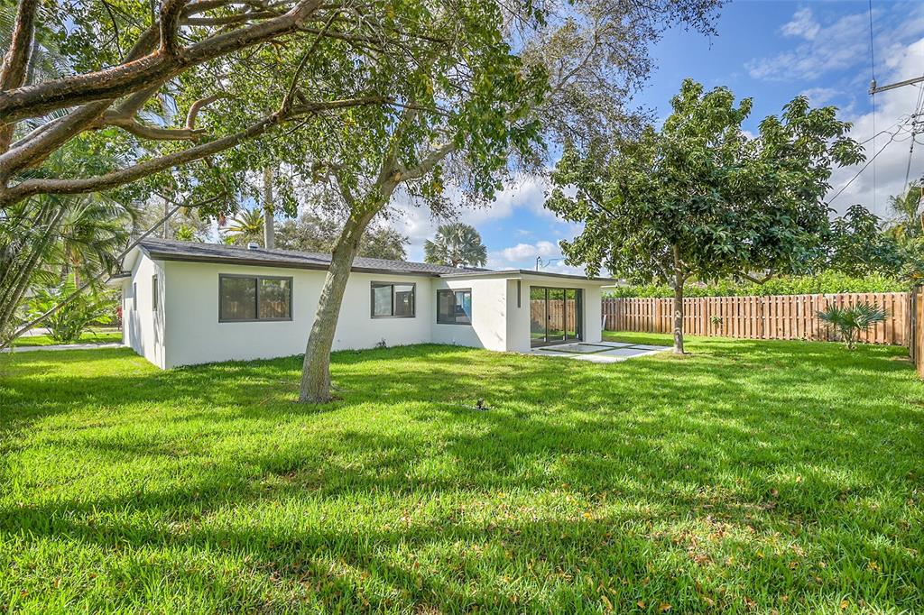 1257 Northwest 4th Street Boca Raton, FL 33486 - Photo 22 of 23 a view of a house with backyard and garden