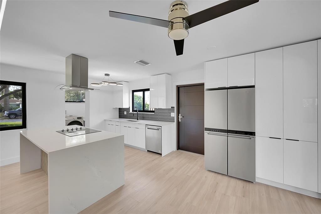 1257 Northwest 4th Street Boca Raton, FL 33486 - Photo 8 of 23 a kitchen with a refrigerator and a stove top oven