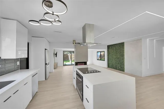 a kitchen with a stove a sink and a refrigerator