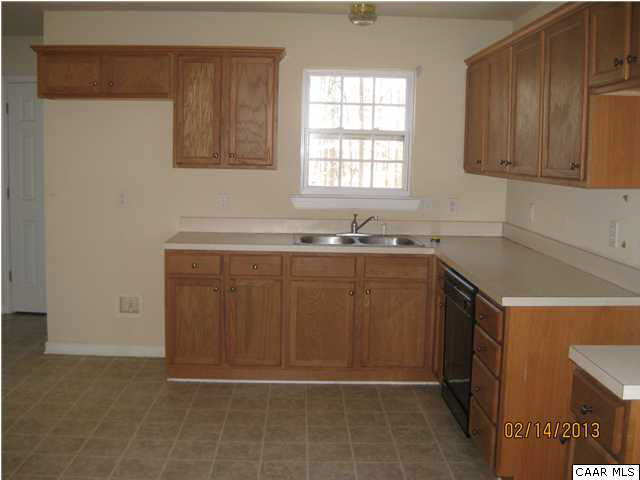 6323 Community House Road Columbia, VA 23038 - Photo 3 of 11 a kitchen with a sink a cabinets and window