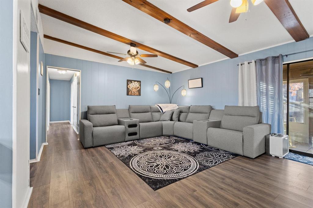 a living room with furniture a couch and wooden floor