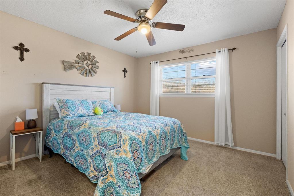 3013 Belle Avenue Denison, TX 75020 - Photo 14 of 32 a bedroom with a bed and a chandelier