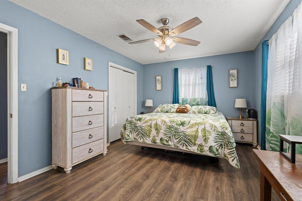 3013 Belle Avenue Denison, TX 75020 - Photo 22 of 32 a bedroom with a bed and a chandelier