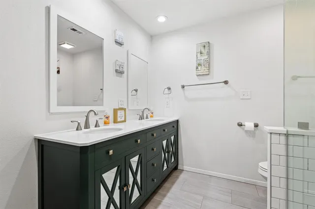 a bathroom with a double vanity sink a and mirror