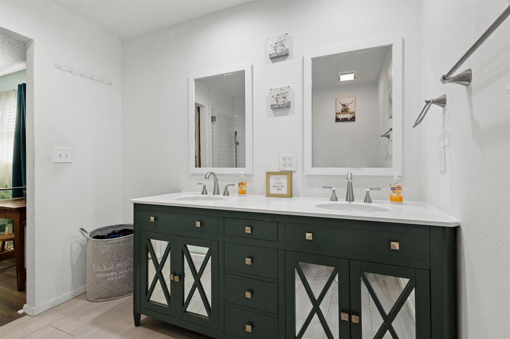 3013 Belle Avenue Denison, TX 75020 - Photo 26 of 32 a bathroom with a sink vanity and mirror
