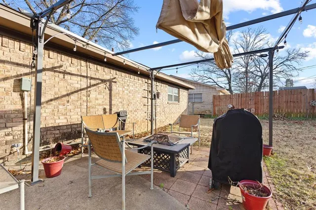 a backyard of a house with table and chairs
