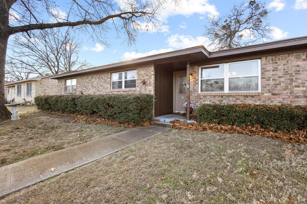 3013 Belle Avenue Denison, TX 75020 - Photo 5 of 32 a front view of a house with garden