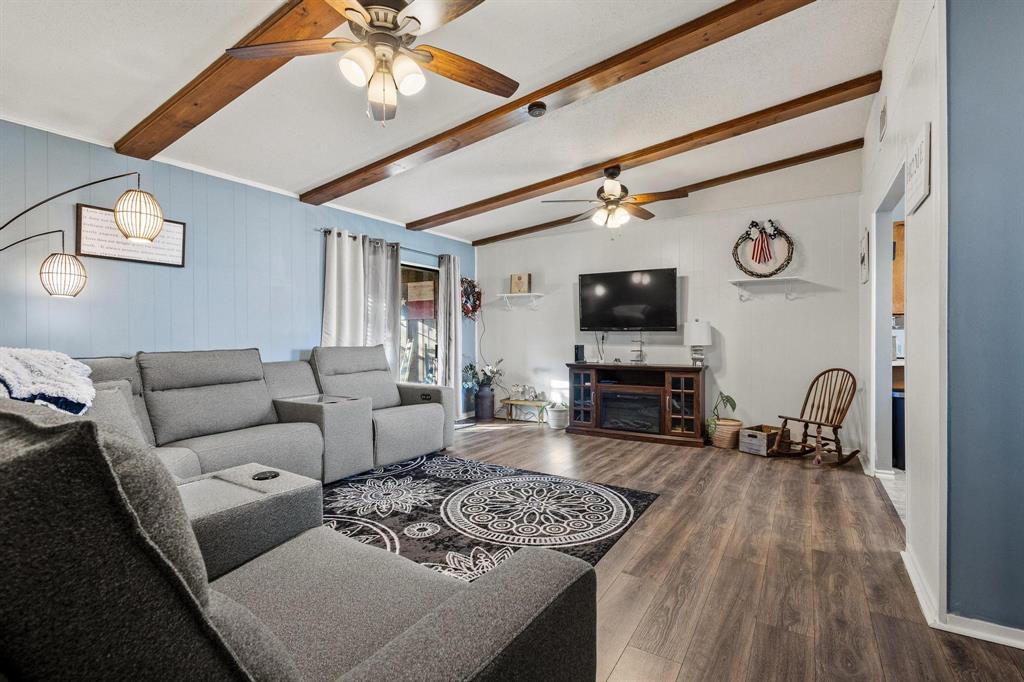 3013 Belle Avenue Denison, TX 75020 - Photo 6 of 32 a living room with furniture a fireplace and a flat screen tv