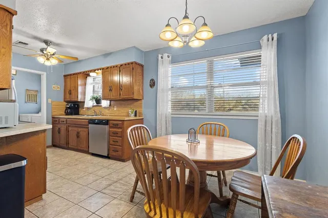 a view of a dining room with furniture and chandelier
