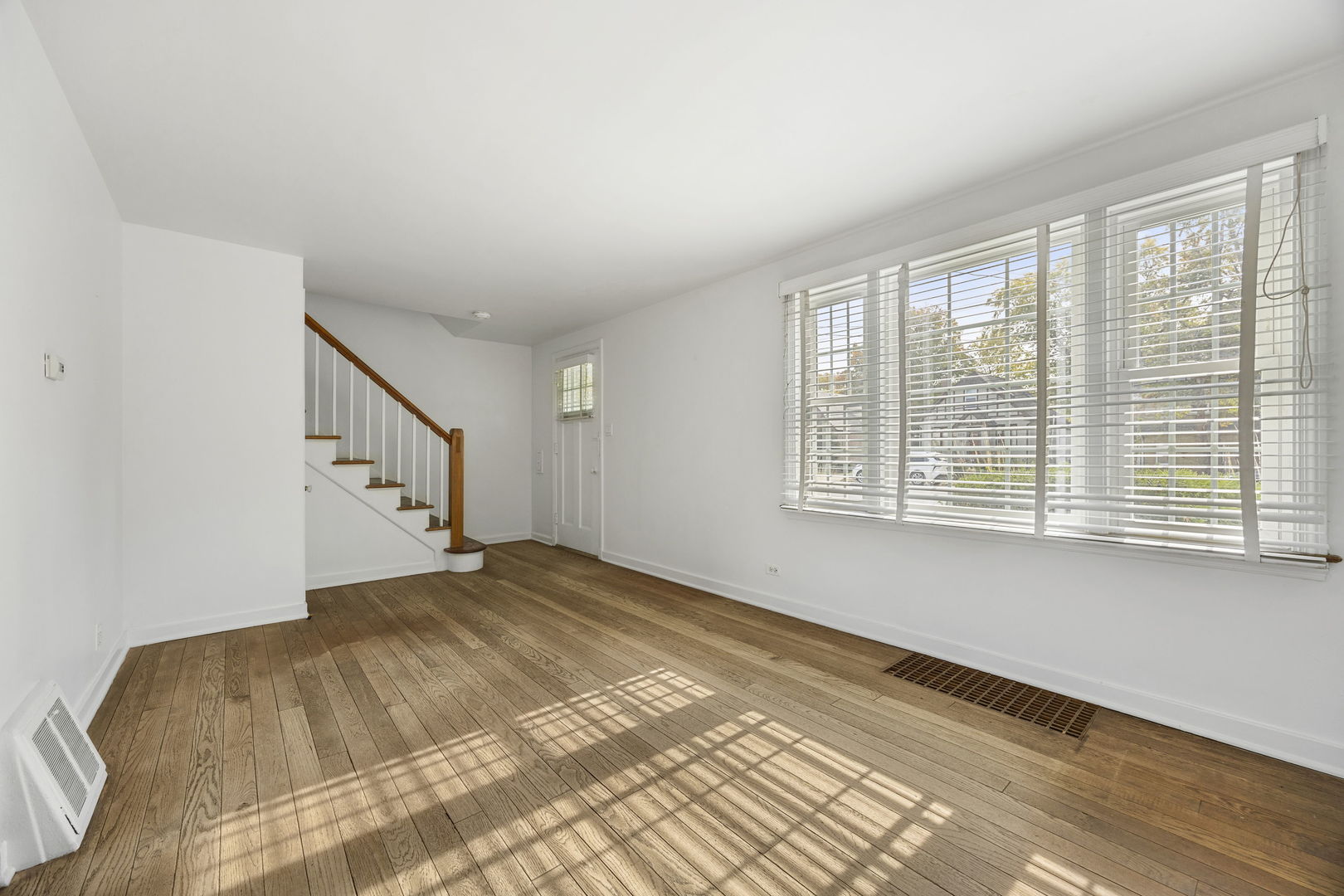 8136 West 26th Street North Riverside, IL 60546 - Photo 3 of 17 a view of a room with wooden floor and windows