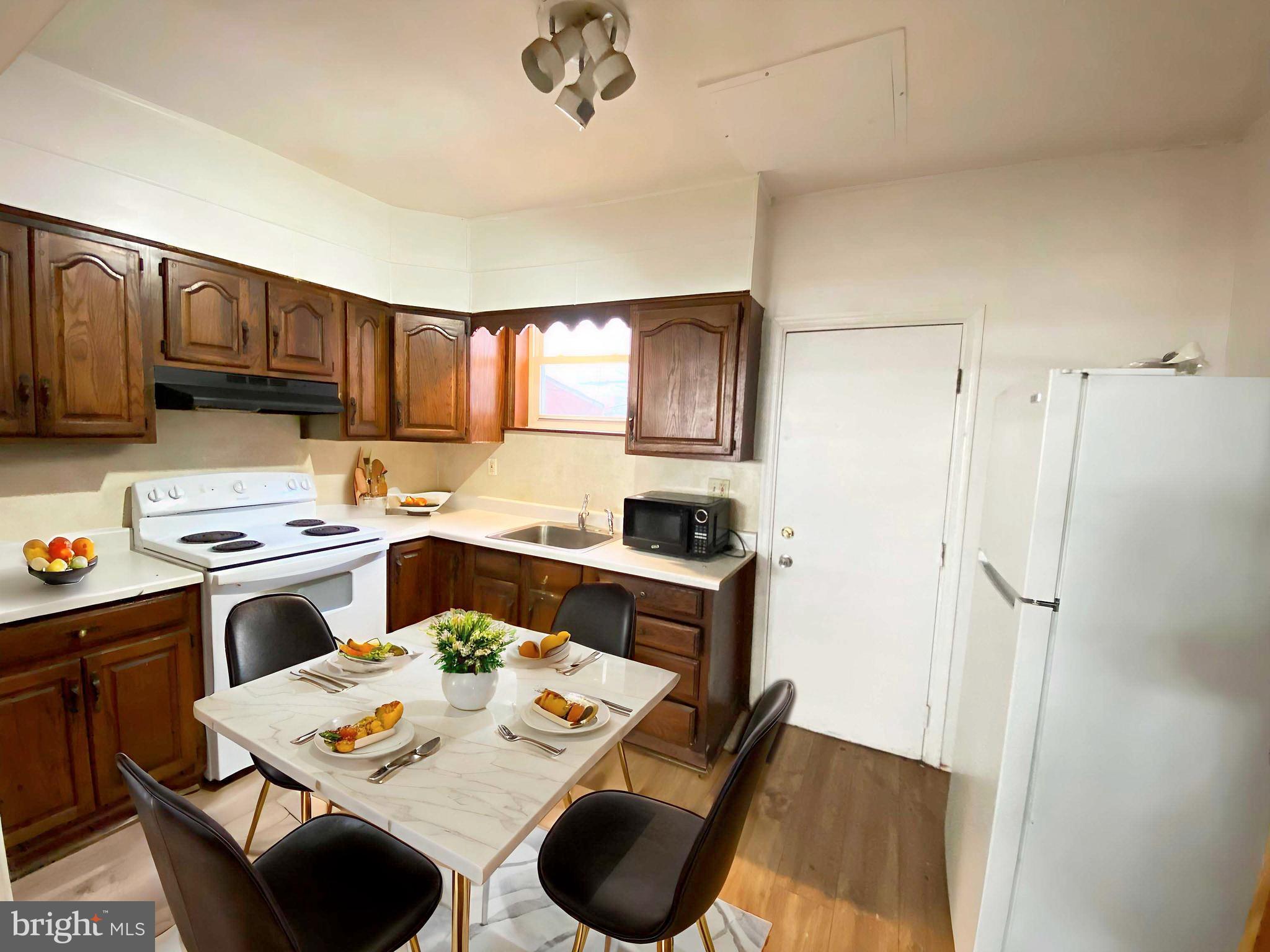 3342 Malta Street Philadelphia, PA 19134 - Photo 12 of 39 a kitchen with stainless steel appliances granite countertop a sink stove and refrigerator