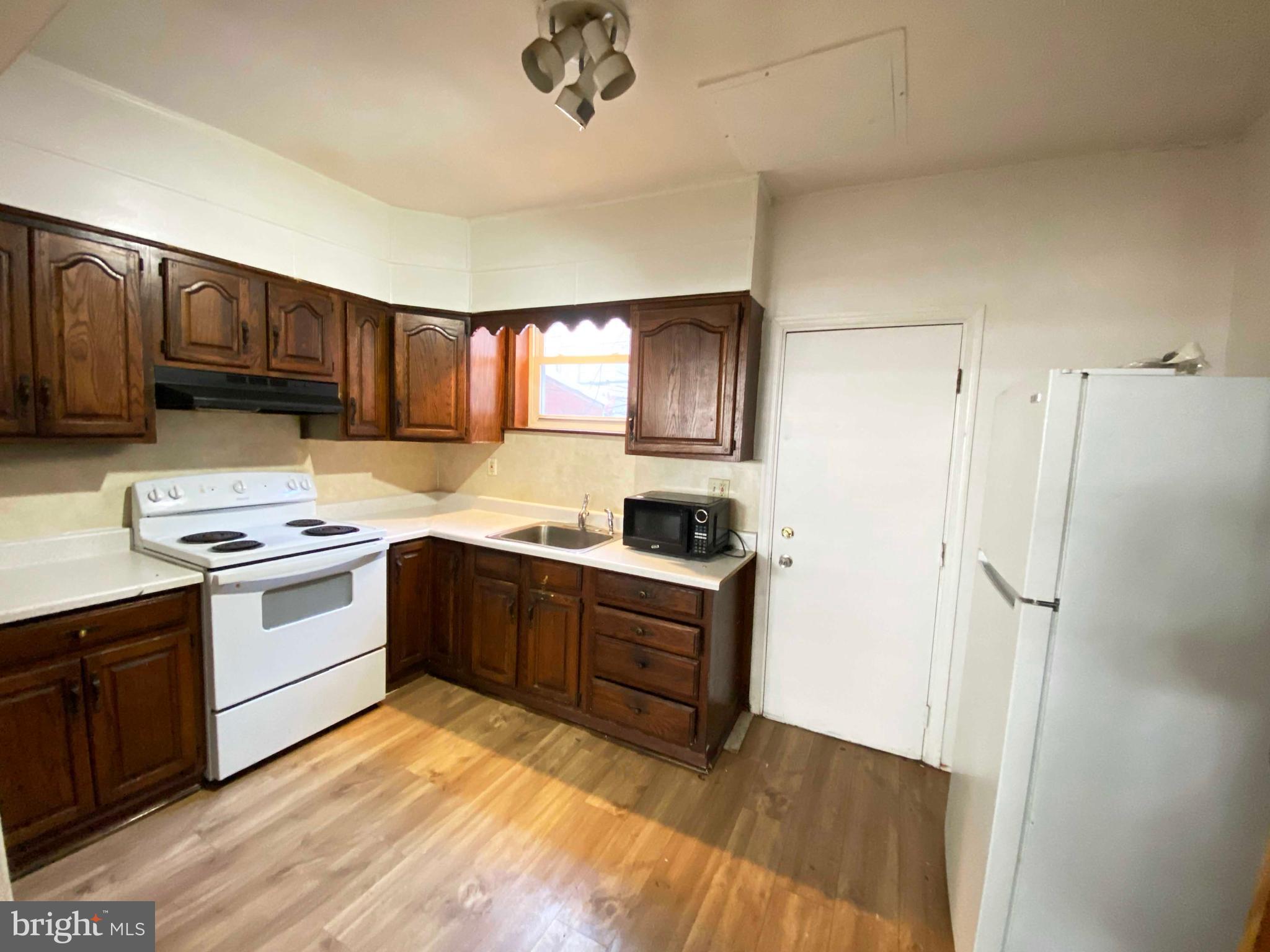 3342 Malta Street Philadelphia, PA 19134 - Photo 13 of 39 a kitchen with stainless steel appliances granite countertop a stove a sink dishwasher and a refrigerator