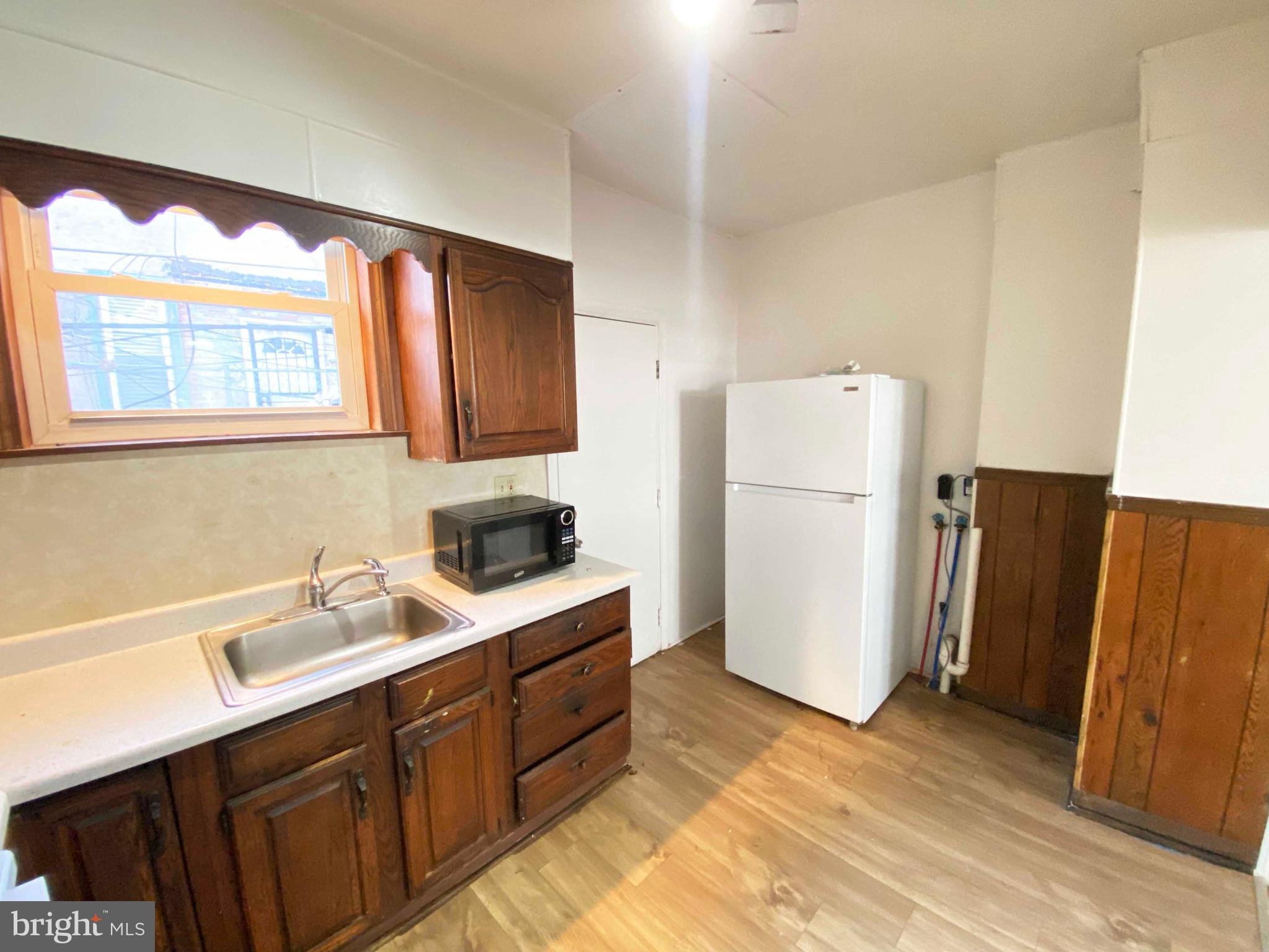 3342 Malta Street Philadelphia, PA 19134 - Photo 15 of 39 a kitchen with a refrigerator sink and stove