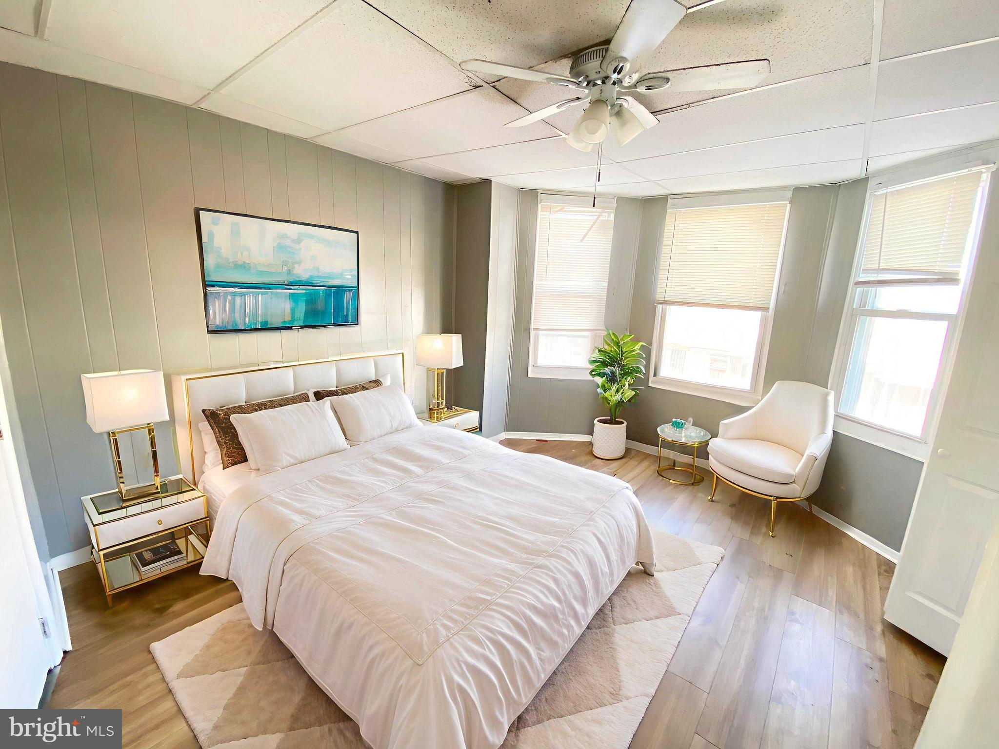 3342 Malta Street Philadelphia, PA 19134 - Photo 20 of 39 a bedroom with a bed a couch and a large window