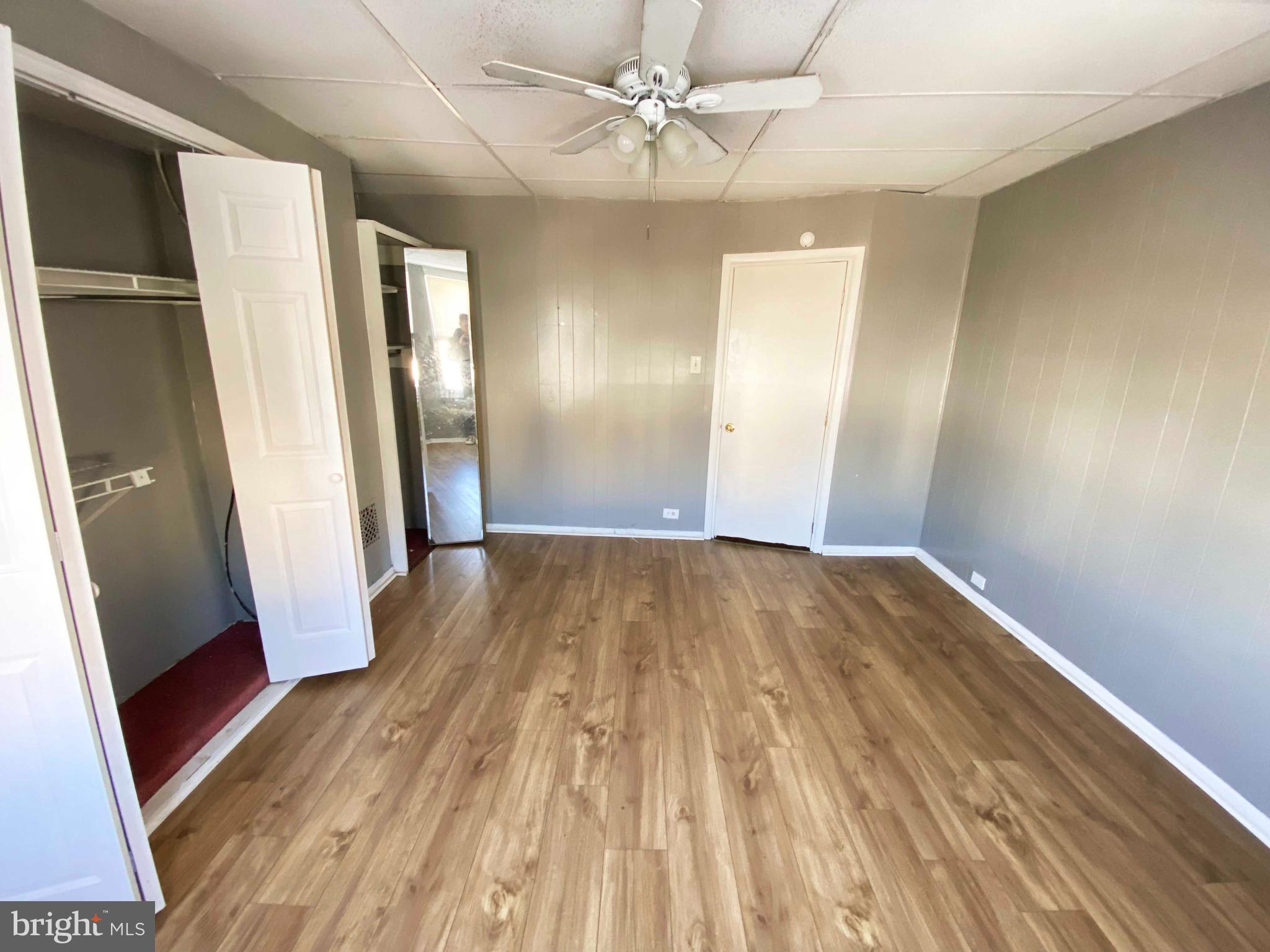 3342 Malta Street Philadelphia, PA 19134 - Photo 23 of 39 wooden floor in an empty room with a mirror