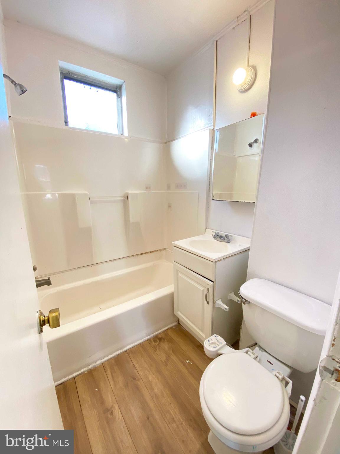 3342 Malta Street Philadelphia, PA 19134 - Photo 24 of 39 a white toilet sitting next to a bathroom sink and tub