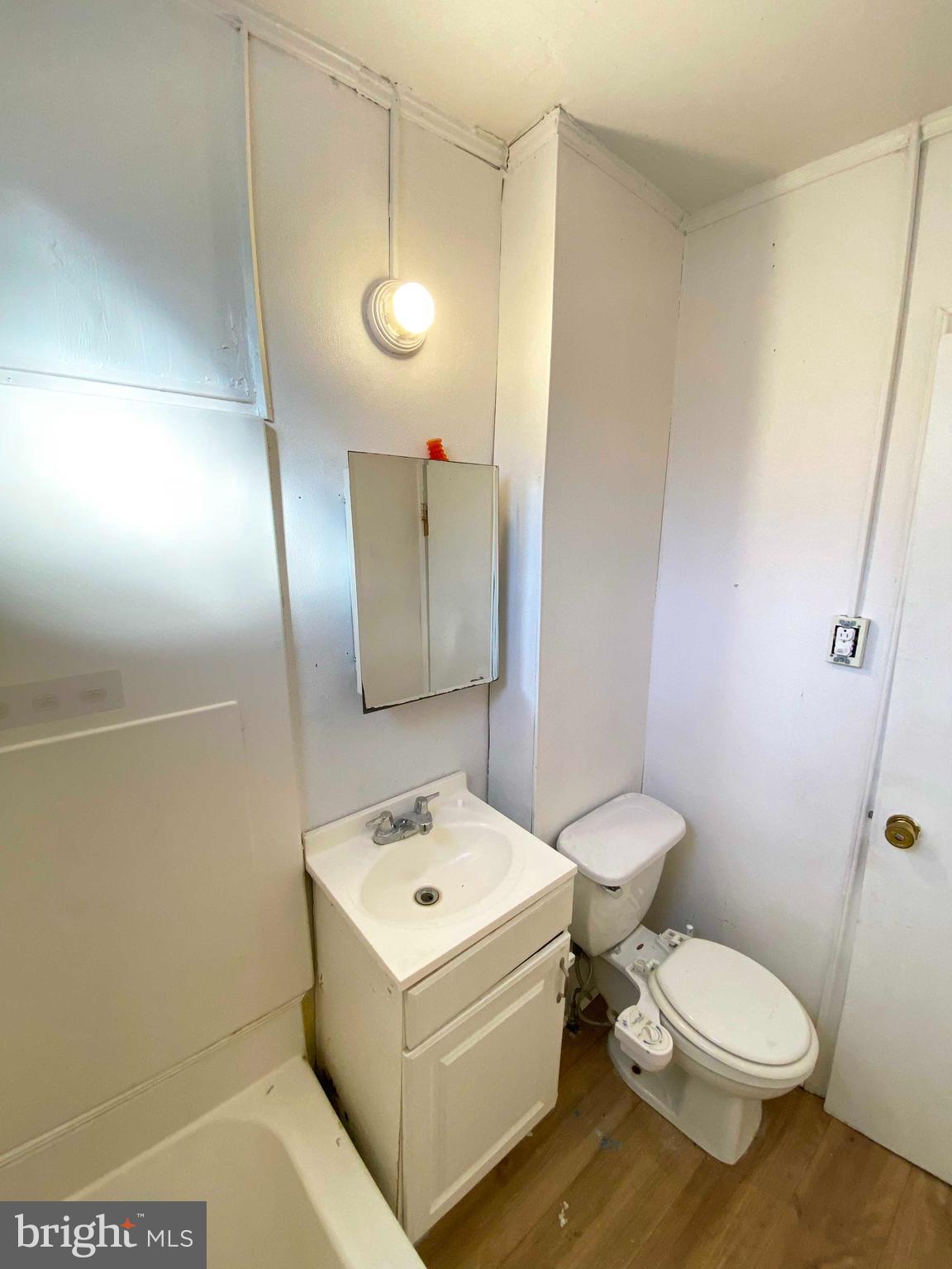 3342 Malta Street Philadelphia, PA 19134 - Photo 25 of 39 a white toilet sitting next to a bathroom sink