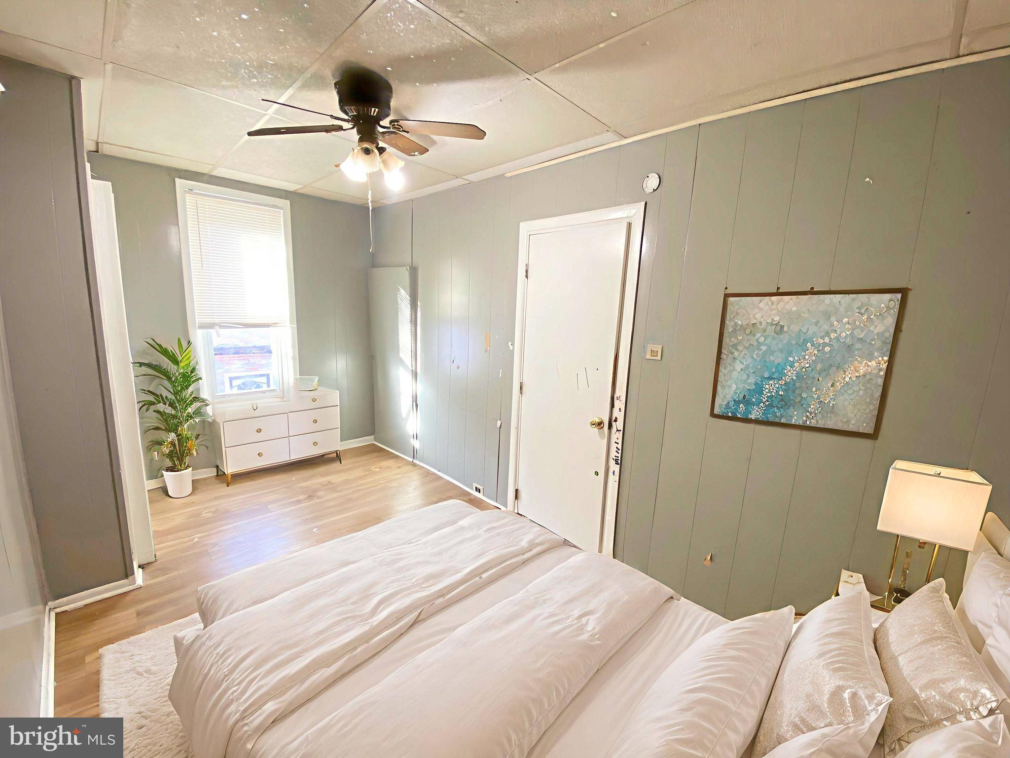 3342 Malta Street Philadelphia, PA 19134 - Photo 27 of 39 a bedroom with a large bed and a chandelier